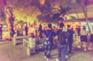 Soyut bulanık insanların gece vakti arka plan kullanımı için yol boyunca yürüdükleri görüntü. (Klasik ton))