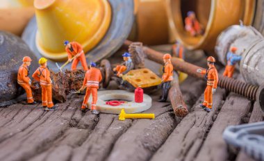 Tuvaletteki ekipmanları tamir eden mini doollerin konsept görüntüsü.