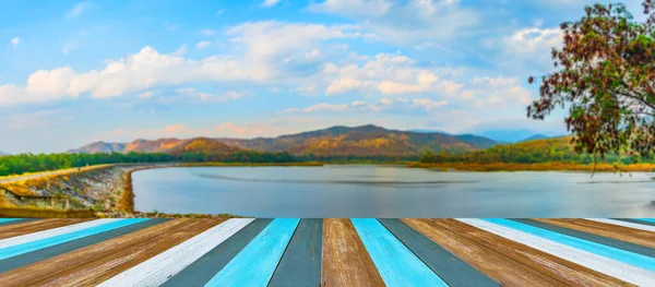 背景为高山蓝天湖泊模糊图像的旧木桌图像 — 图库照片
