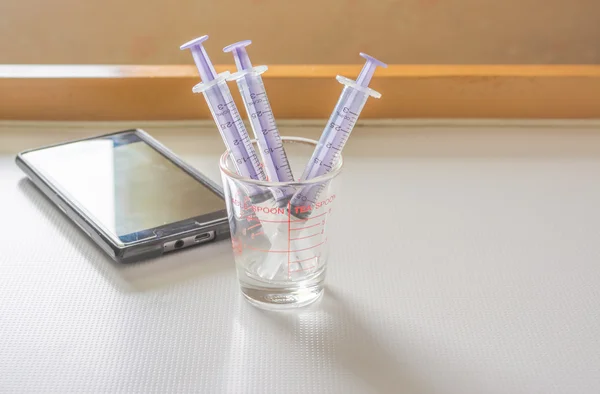 Syringe And smart phone — Stock Photo, Image