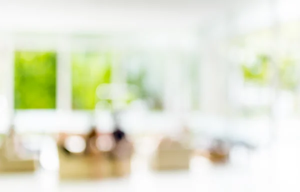 blur image of people sit in living room .