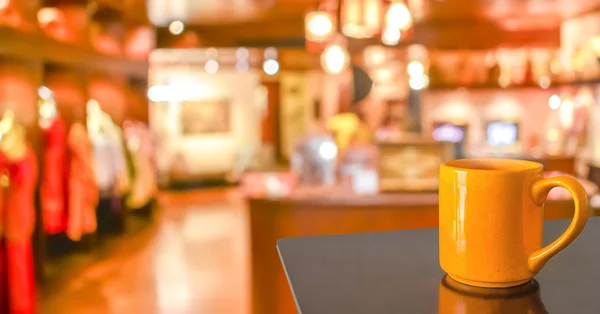 Empty wood table and Coffee shop blur background with bokeh image.