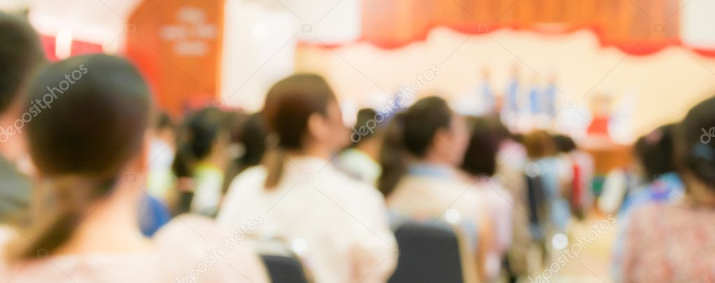 blur image of Parent looking at kids on school stage.
