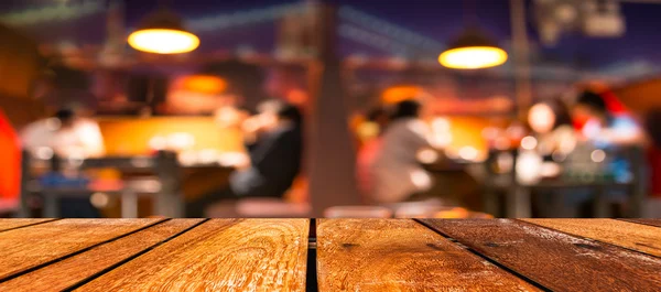 Mesa de madera marrón vacía y fondo borroso de la cafetería con imagen bokeh —  Fotos de Stock