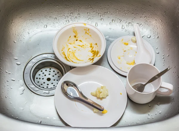 Kitchen conceptual image. Dirty sink with many dirty dishes.