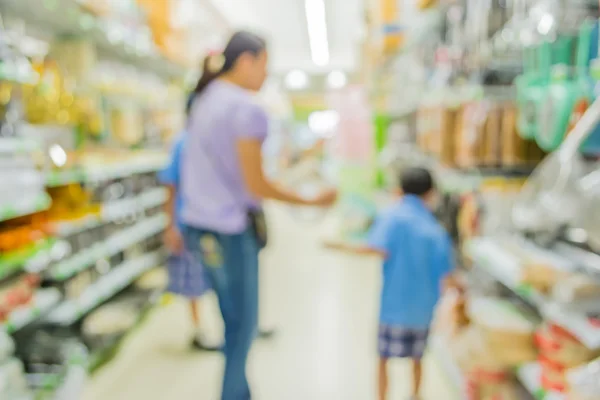 blurred image of shopping mall and people for background usage .