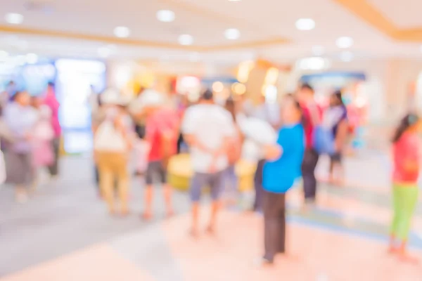 blurred image of shopping mall and people.
