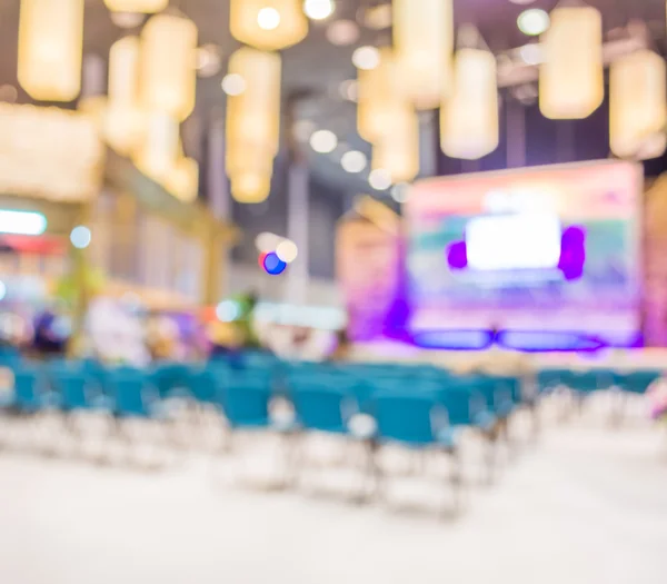 Blurred image of people in auditorium , blur background with bokeh .