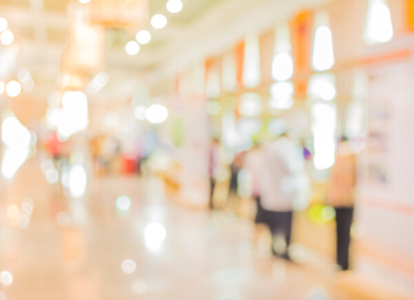 blurred image of shopping mall and people