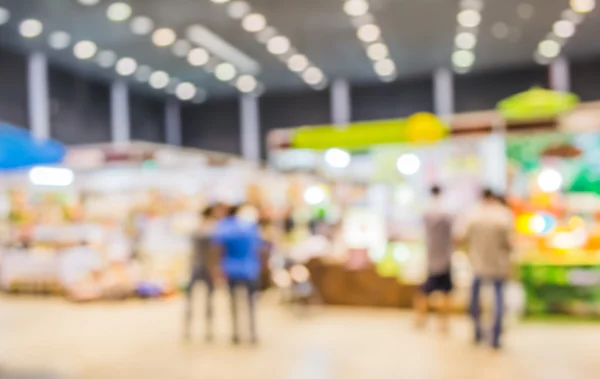 blurred image of shopping mall and people