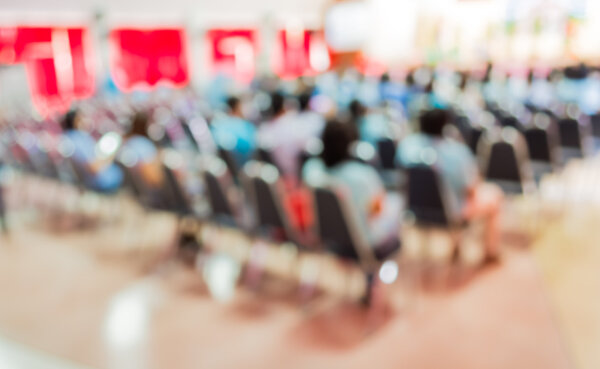 Blurred image of people in auditorium 