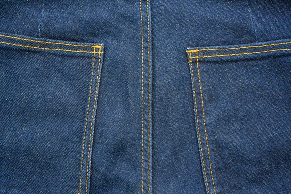 Backside denim blue jeans pocket closeup. Denim jeans texture. Blue jeans texture with pocket for any background.