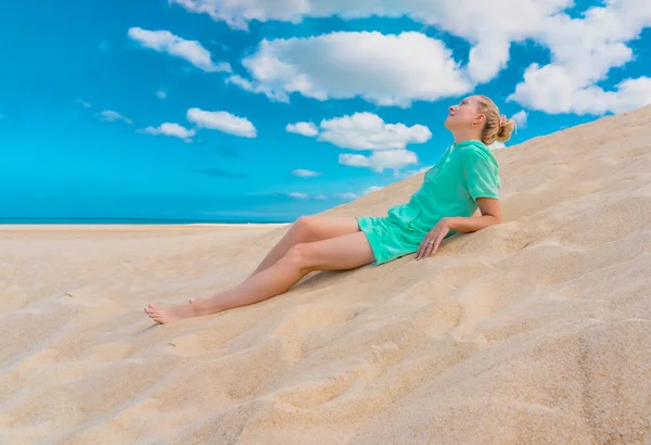 Beautiful woman relaxing on the sand against the background of the sky. Woman lying on the nature. Relax, meditation concept. — Stock Photo, Image