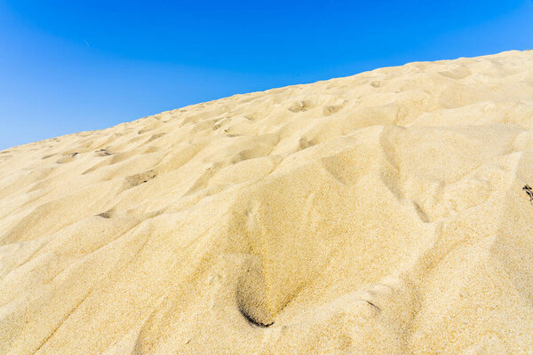 Красивый пейзаж с белыми песчаными дюнами и голубым небом. 