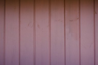 Açık pembe boyayla boyanmış tahta tabloların arka planı