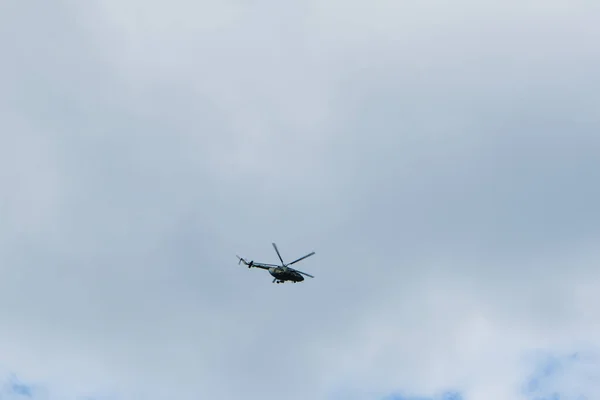 helicopter on a background of blue sky with clouds