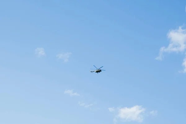 helicopter on a background of blue sky with clouds