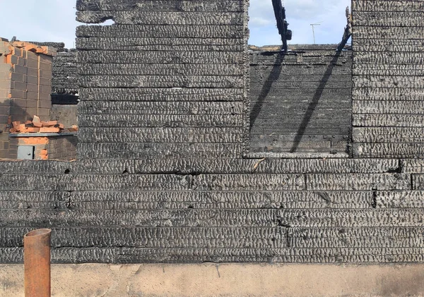 burnt down wooden house, charred dwelling, ashes