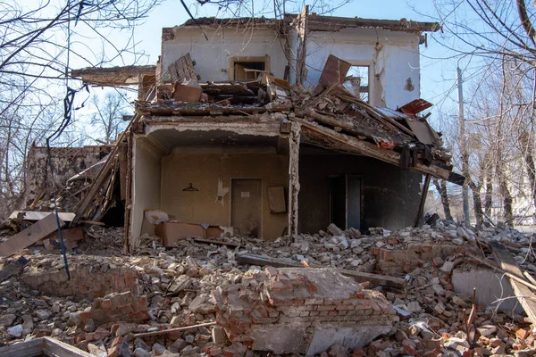 dismantling of an old building, collapsed from a cataclysm or old age, a building without a wall and a roof with a rickety second floor, a bunch of bricks and rubbish.