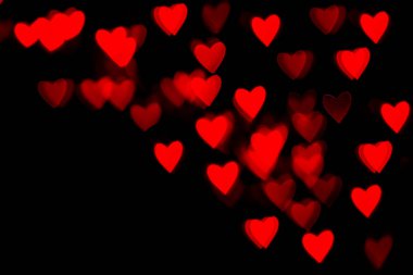 Valentine grunge kalp şeklindeki ışıklar arka planda. Siyah arka planda kırmızı kalp şeklinde. Kırmızı bokeh kalbi hafif, kalbi renkli.