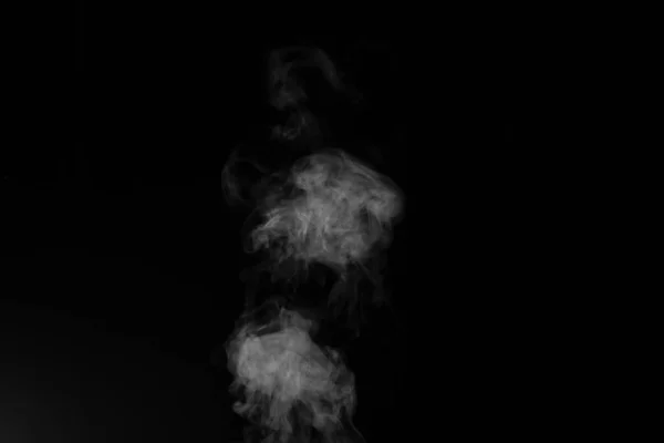White smoke on black background. Figured smoke on a dark background. Abstract background, design element, for overlay on pictures