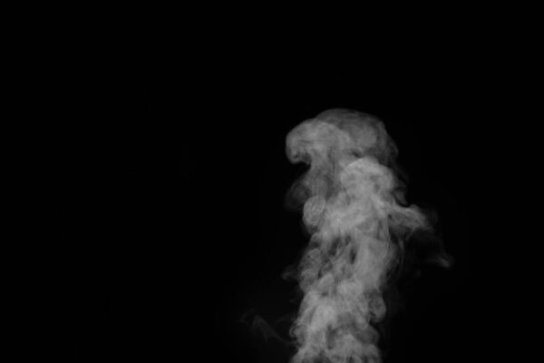 Smoke fragments on a black background. Abstract background, design element, for overlay on pictures.