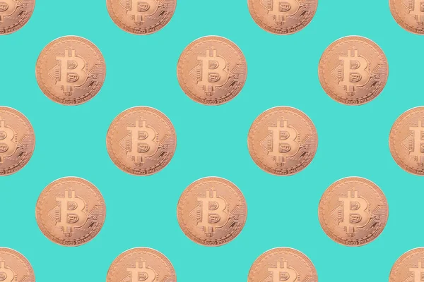 Seamless pattern of gold coin bitcoin on a blue background close-up. Physical bit coins background. Digital currency background. Electronic money concept