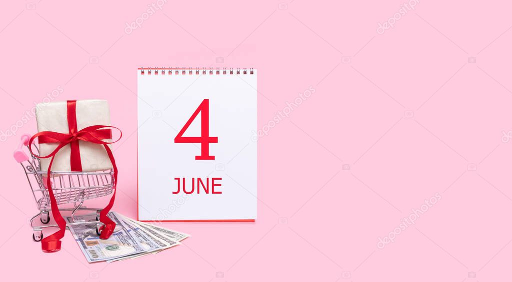 4th day of june. A gift box in a shopping trolley, dollars and a calendar with the date of 4 june on a pink background. Summer month, day of the year concept.