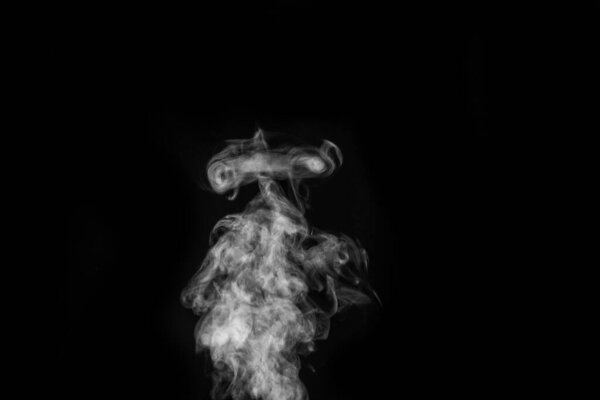 Perfect mystical curly white steam or smoke isolated on black background. Abstract background fog or smog