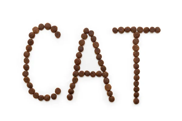 Сухой корм для кошек в виде букв CAT, выделенных на белом фоне. Концепция здорового питания для животных. — стоковое фото