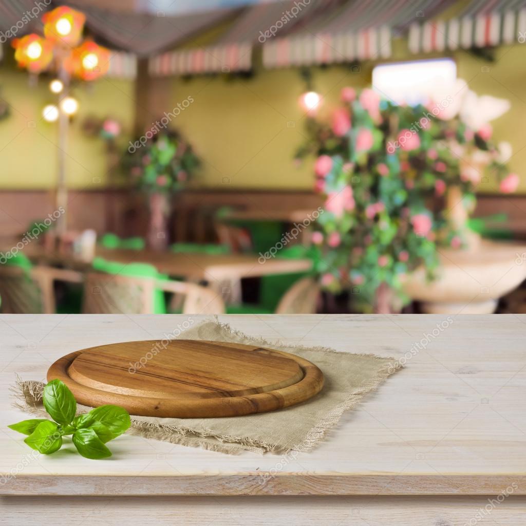 Round Board On Kitchen Table Over Cafe Interior Background Stock