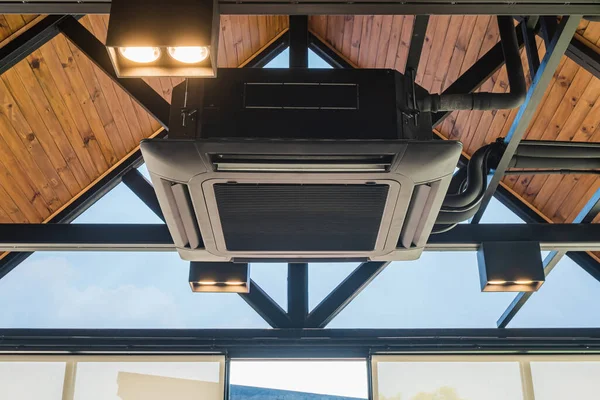 Ceiling mounted cassette type air conditioner in the cafes. Ceiling air conditioning system, open-air, circulating air throughout the modern style, popular installed in coffee shops.