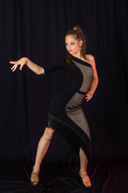 Beauty teen in black latin dance clothes clipart