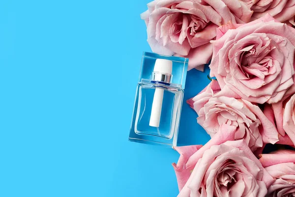 Parfümglasflasche Und Rosa Rosen Auf Blauem Hintergrund — Stockfoto