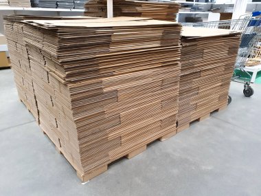 Depo veya nalbur dükkanında katlanmış kağıt kutu yığını