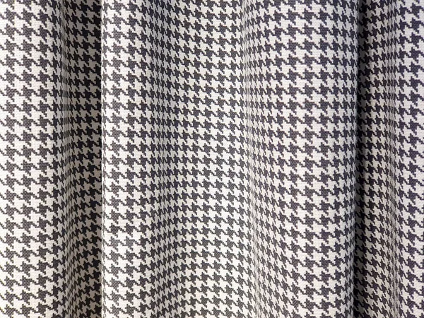 Houndstooth check pattern Fabric. Suit polyviscose fabric. Black and white blackout curtains. Close-up. Herringbone cotton pattern, cotton fabric background texture. Interior material background.