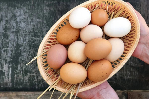 Farmer Hands Hold Domestic Hens Eggs Basket Old Wooden Texture — Foto de Stock