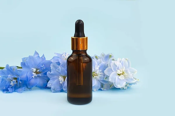 Serum Unbranded Brown Glass Bottle Pipette Blue Delphinium Flower Blue — Stock Photo, Image