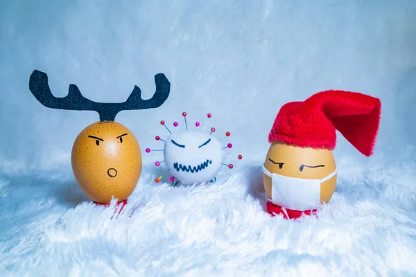 Cute painted eggs with corona virus doll to celebrate Christmas in times of covid pandemic. Fun indoor activity with kids. — Stock Image Cute Painted Eggs Corona Virus Doll Celebrate Christmas Times Covid Stock Picture