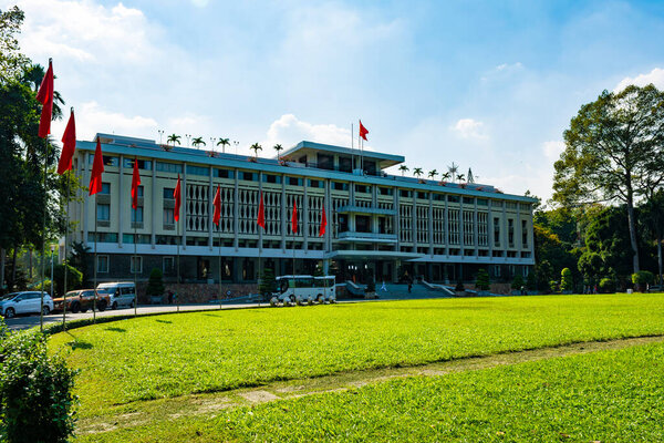 Ho Chi Minh City, Vietnam - CIRCA Jan 2020: The facade of Independence Palace, Ho Chi Minh City, Vietnam; with several Vietnamese national flags around its lawn.