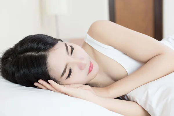 young beautiful woman sleeping on bed