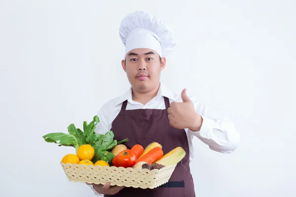 Retrato de un chef sosteniendo frutas y verduras —  Fotos de Stock
