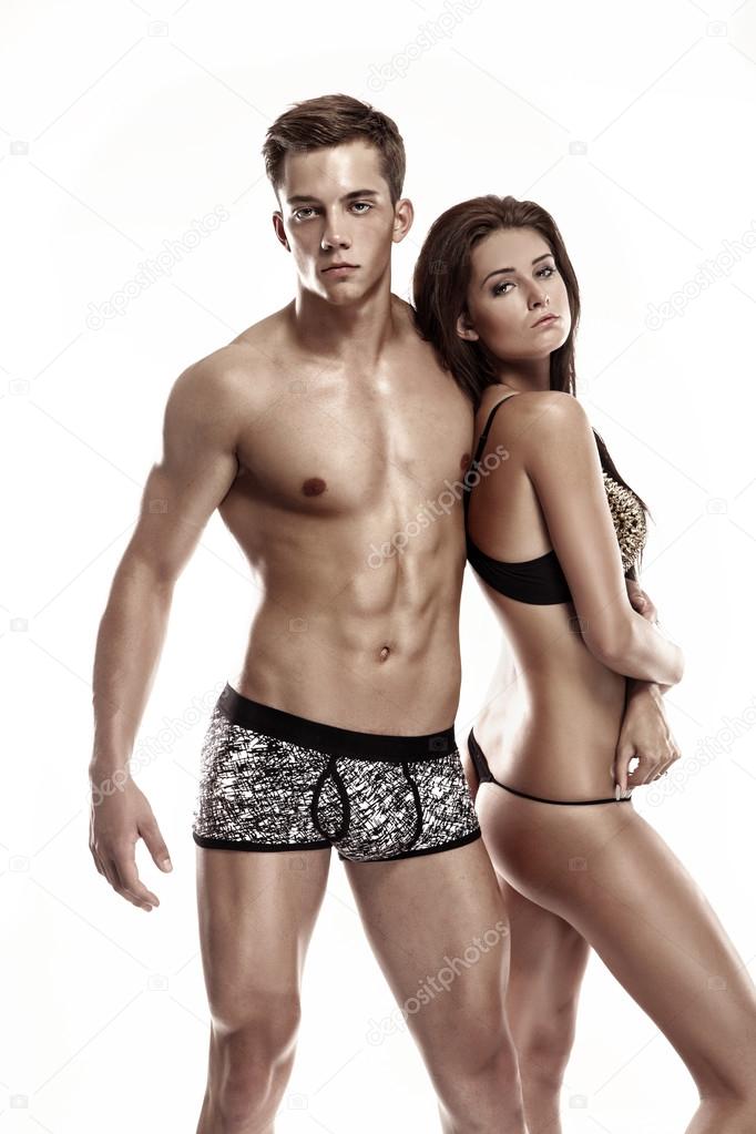 Sexy couple, woman holding a muscular man