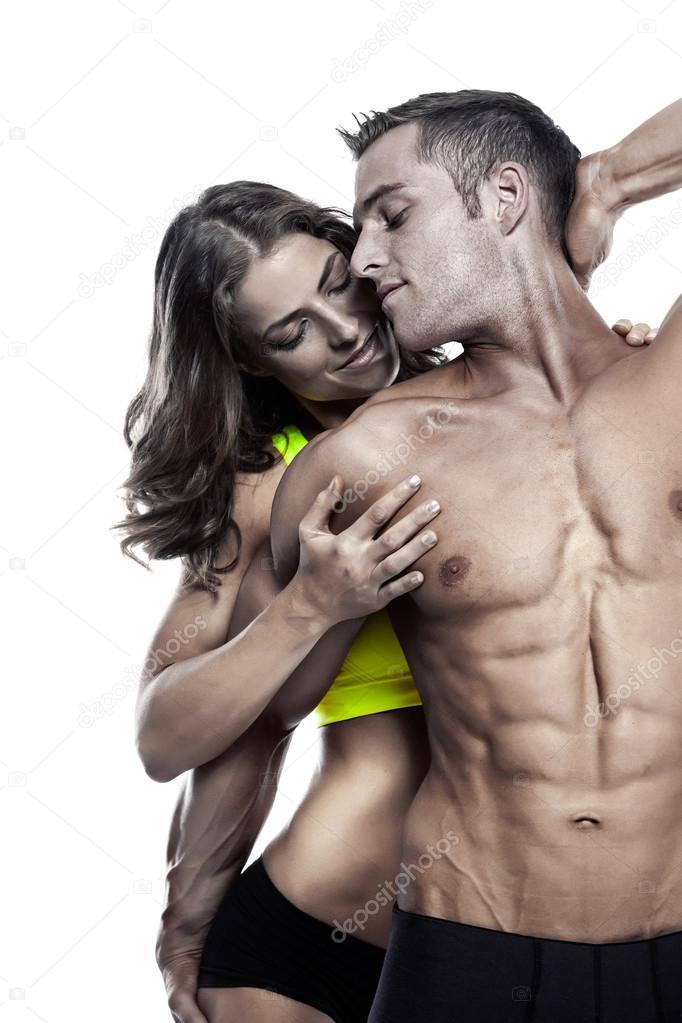 sexy couple, muscular man holding a beautiful woman isolated on 