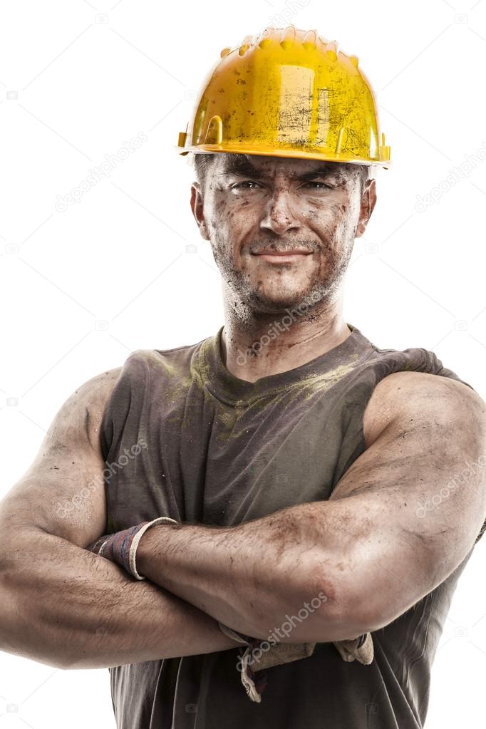 Dirty worker with helmet crossed arms