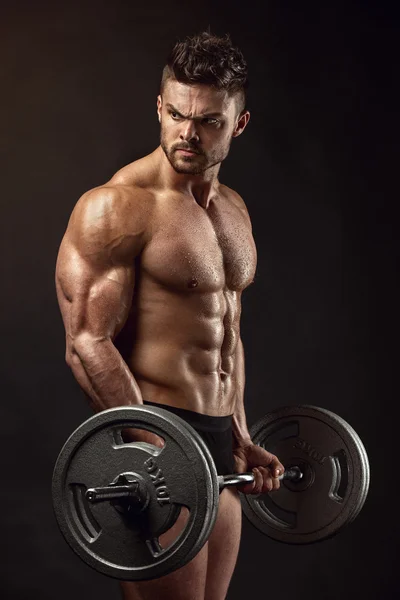 Muscular bodybuilder guy doing exercises with big dumbbell — Stock Photo, Image