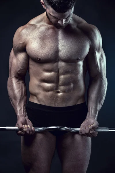 Muscular bodybuilder guy doing exercises with big dumbbell — Stock Image Muscular bodybuilder guy doing exercises with big dumbbell Royalty Free Stock Photos