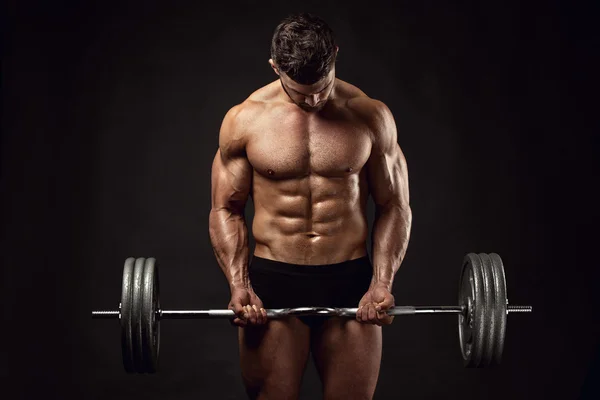 Muscular bodybuilder guy doing exercises with big dumbbell — Stock Photo, Image