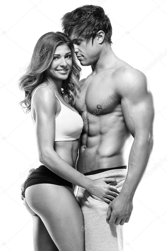 sexy couple, muscular man holding a beautiful woman