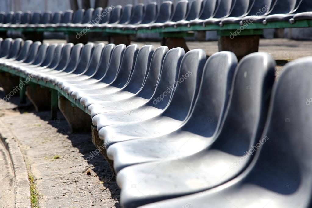 Row of black seats on tribune 